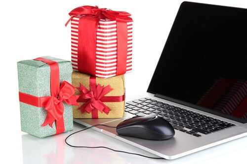 Laptop, gifts and computer mouse isolated on white