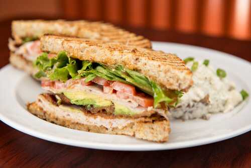 Roasted turkey with avocado slices on whole wheat bread