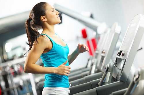 Woman is running on the treadmill