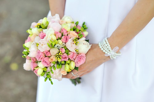 Carrying a bridal bouquet