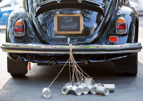 Tying tin cans to the newlywed couple's car