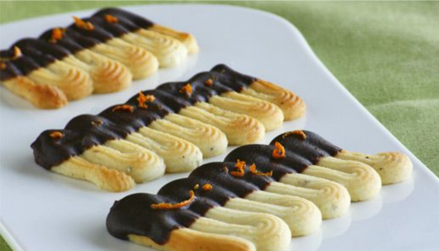 Orange-Flavored Spritz Sable Cookies dipped in Dark Chocolate